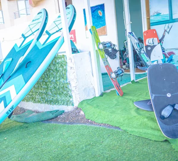 Twintip and directional kiteboards stored on the rack at the kite centre