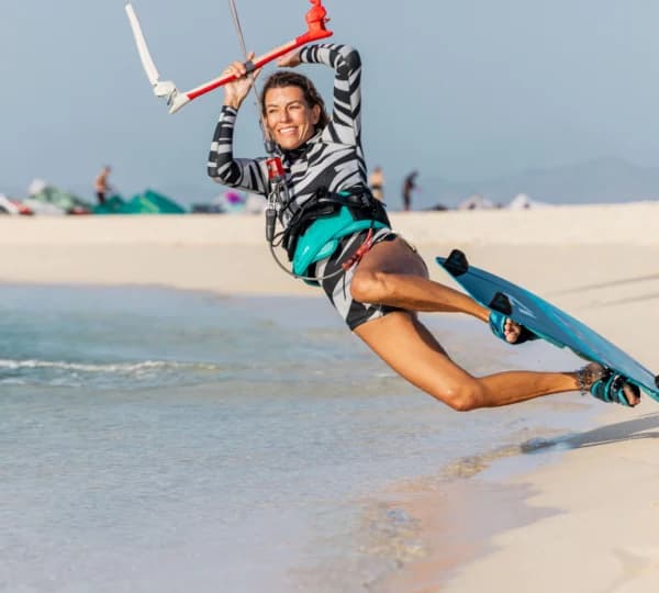 Complete kitesurfing setup with kite, board and bar ready to ride